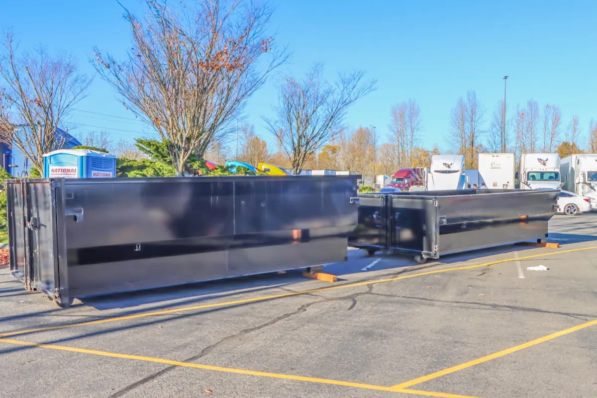 Professional dumpster rental service with roll-off container on residential driveway in Conewago